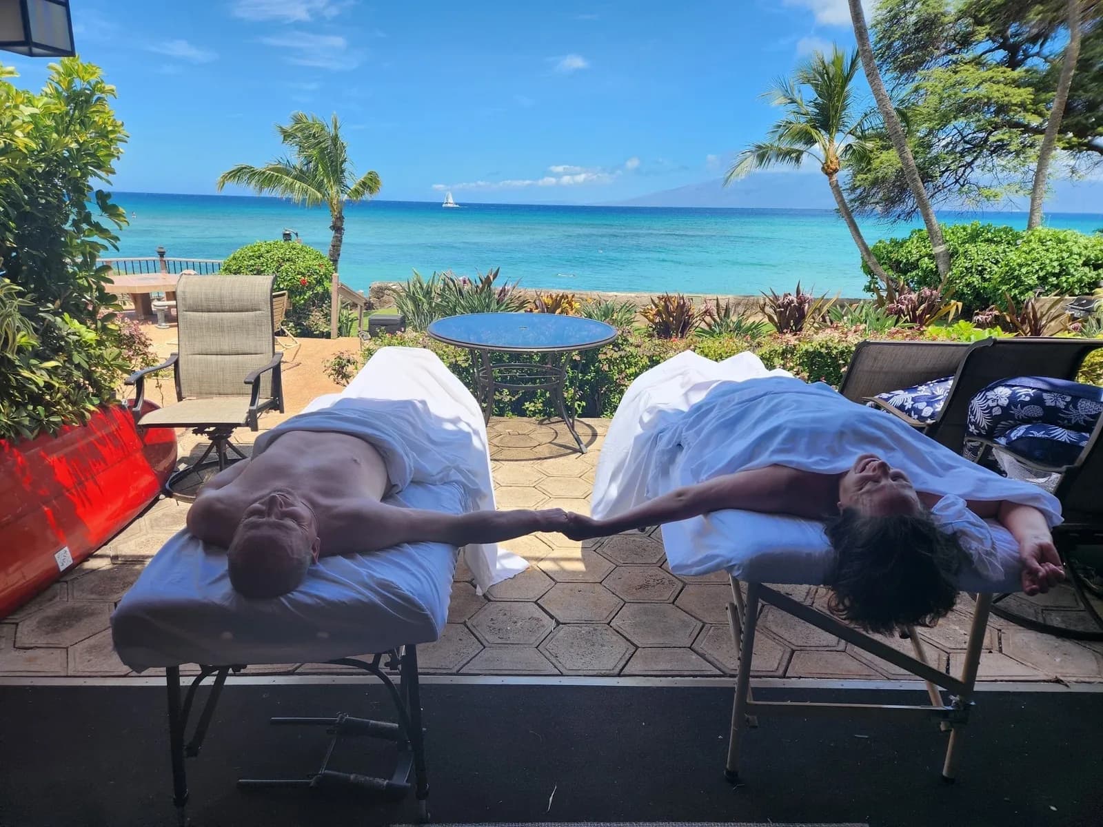 Side-by-side massage on a hotel patio facing the ocean