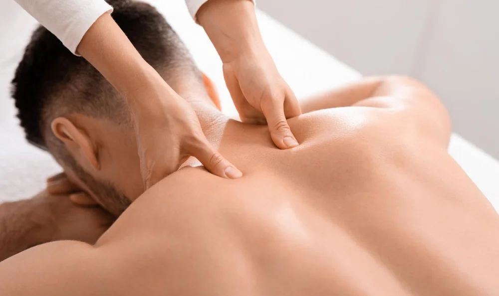 Focused thumb pressure on a client's upper back