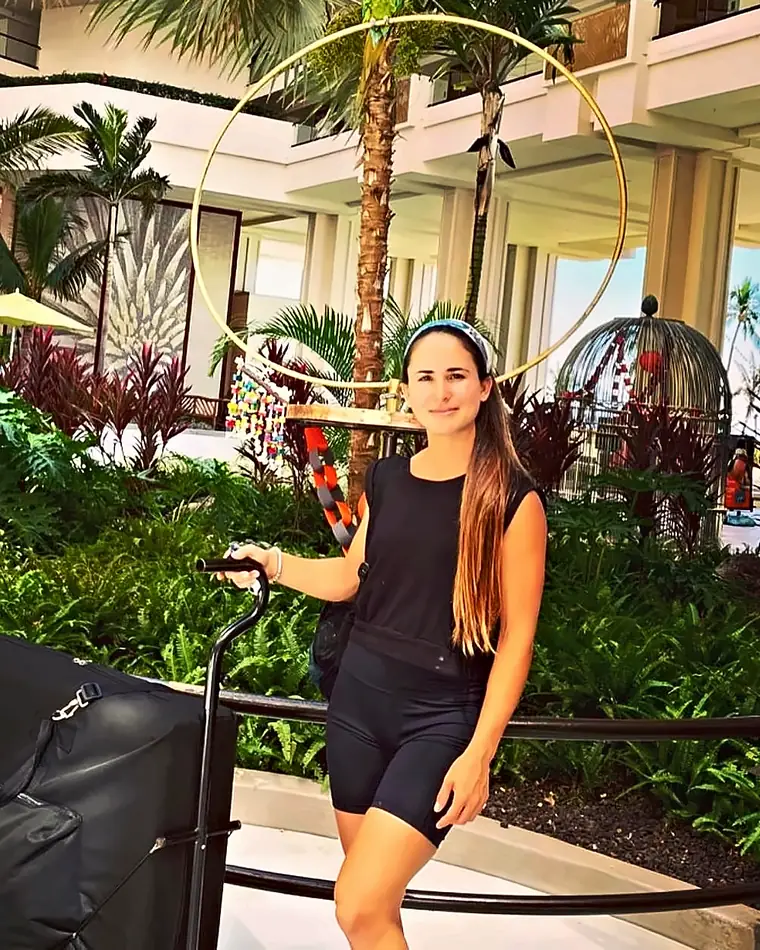 Maria, licensed massage therapist at Maui Premier Massage, arriving at a Maui resort with professional equipment